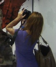 a woman taking a picture of a man in a military uniform