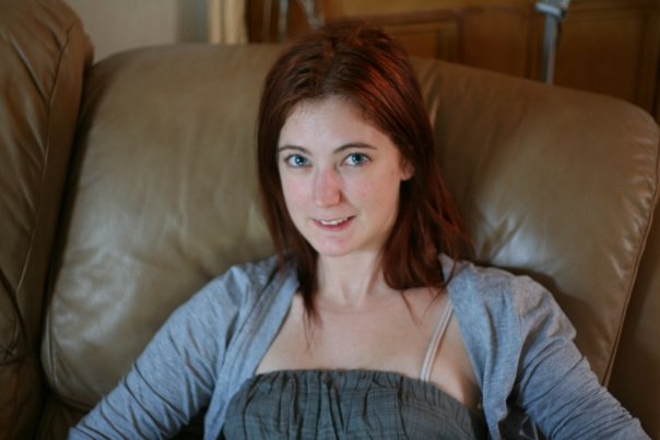 a woman sitting on a couch with a book