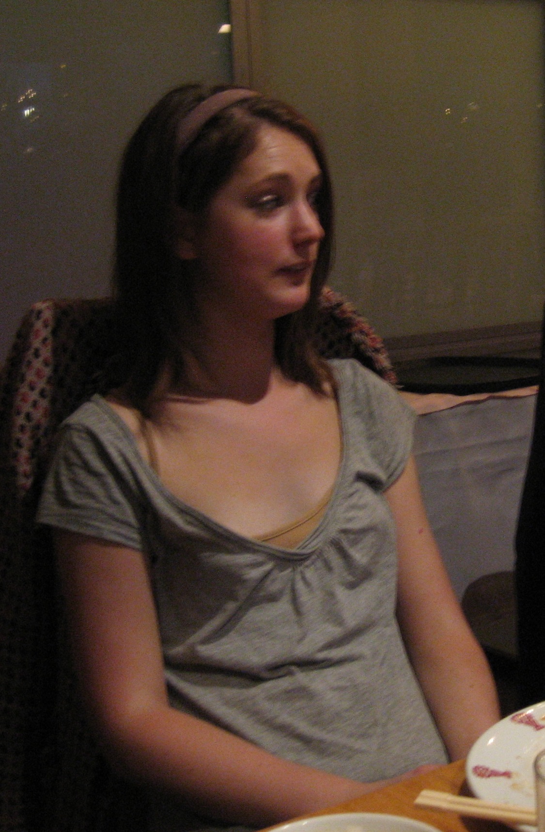 a woman sitting at a table with a plate of food