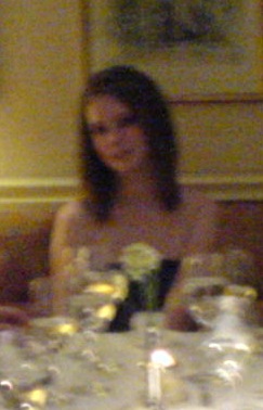 a woman sitting at a table with a bunch of flowers