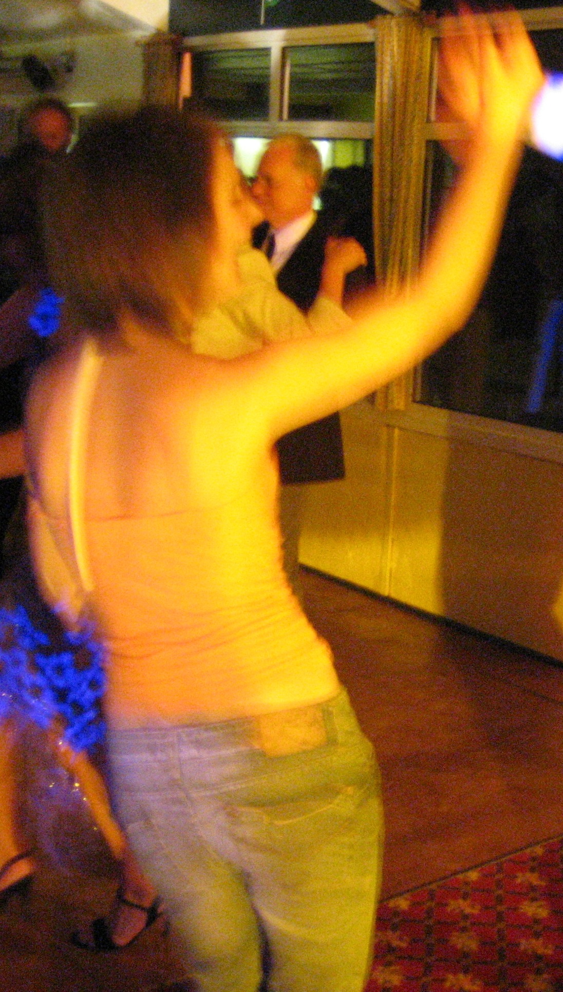 a woman is dancing in a room with a mirror