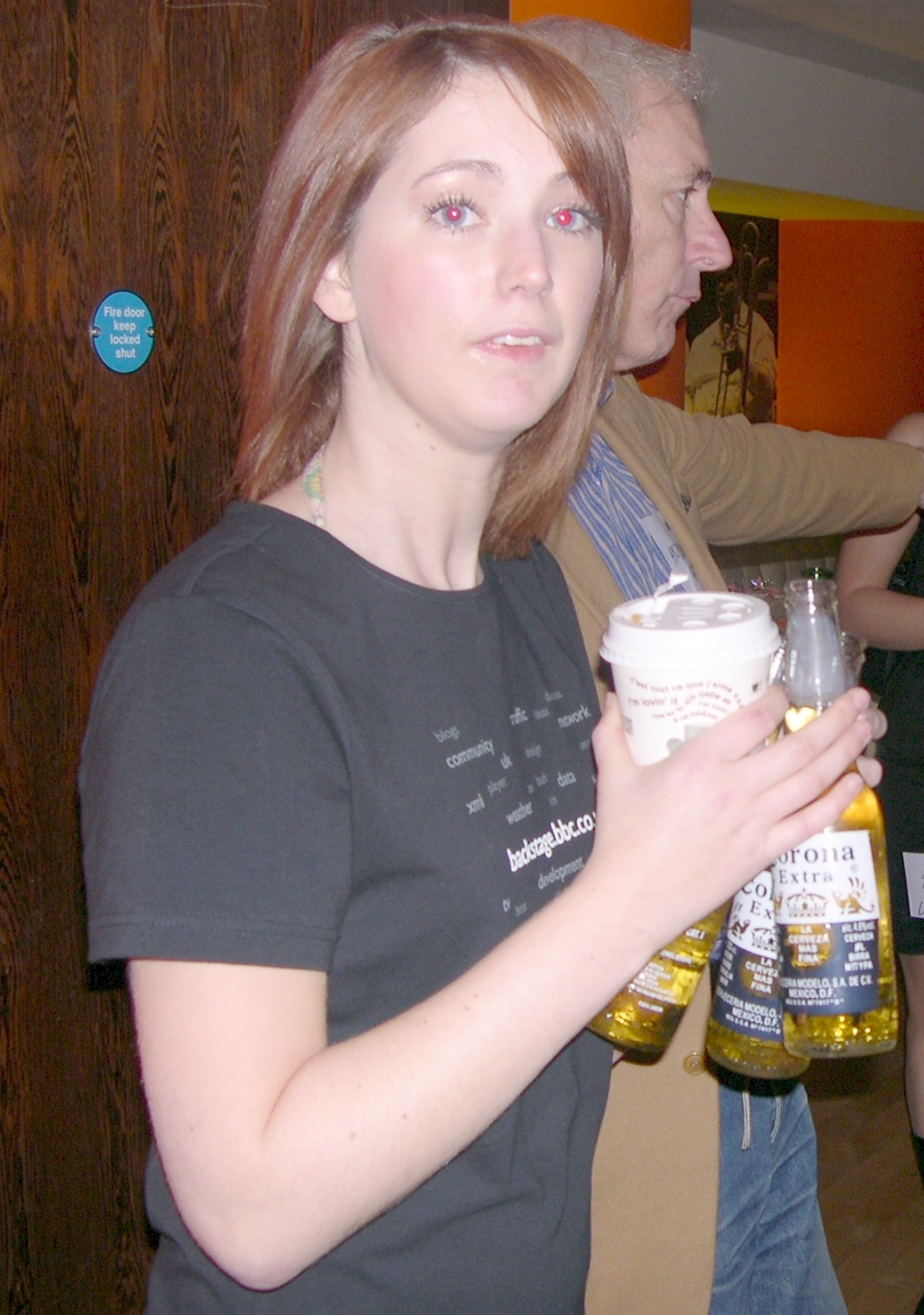 a woman holding a beer