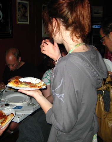 a woman holding a plate of pizza