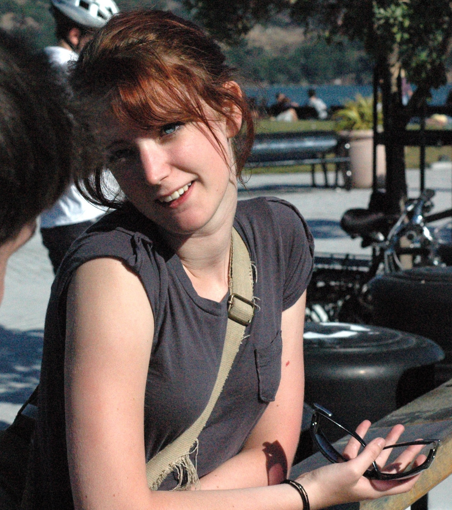 a woman sitting on a bench with a cellphone phone