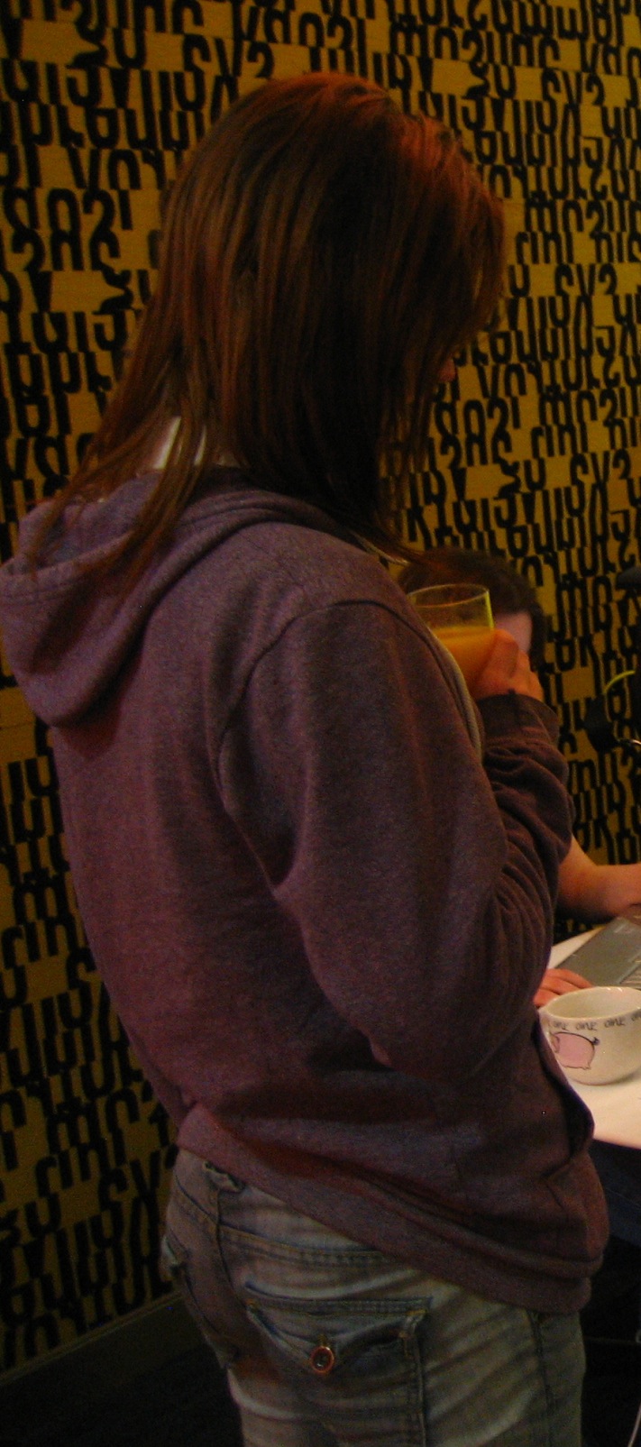 a woman is standing in front of a laptop