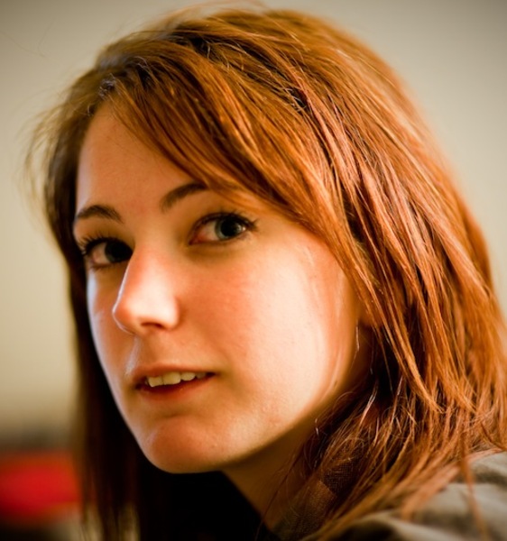 a woman with red hair and a black shirt