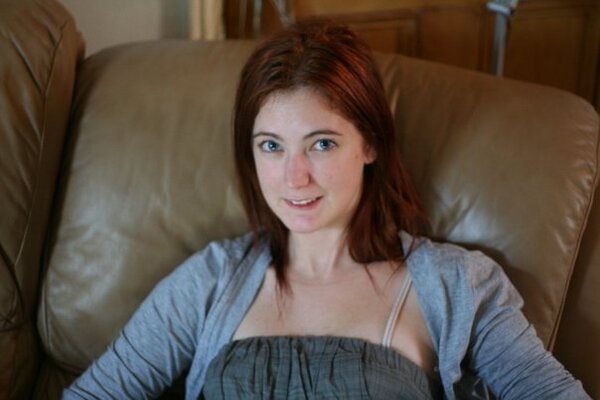 a woman sitting on a couch with a book