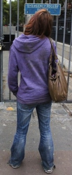 a woman walking down the street with a bag