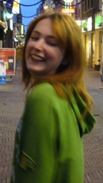 a woman walking down a street in a city