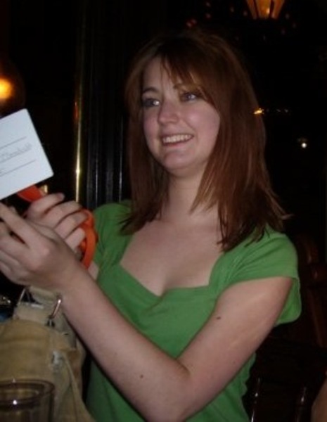 a woman holding a paper card