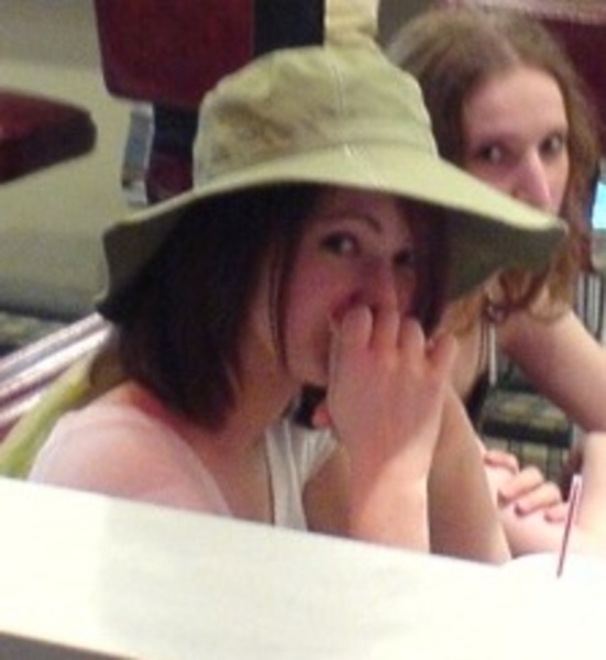 a woman sitting at a table with a laptop