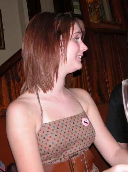 a woman sitting at a table with a glass of wine