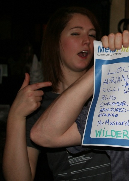 a woman holding a sign with a note on it