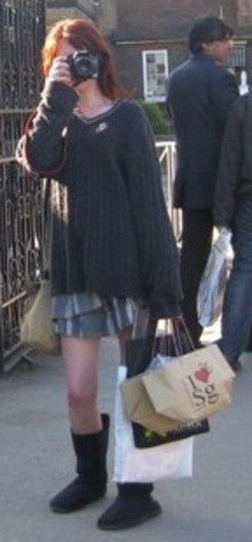 a woman walking down a street with a bag