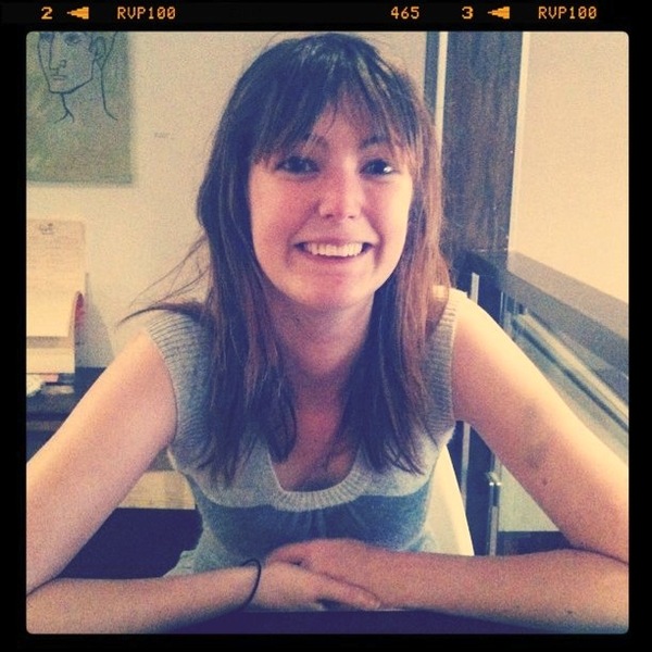 a woman sitting at a table with her arms crossed