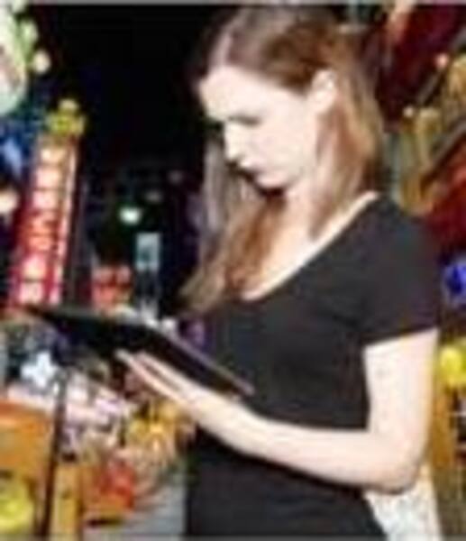 a woman standing in front of a bar a