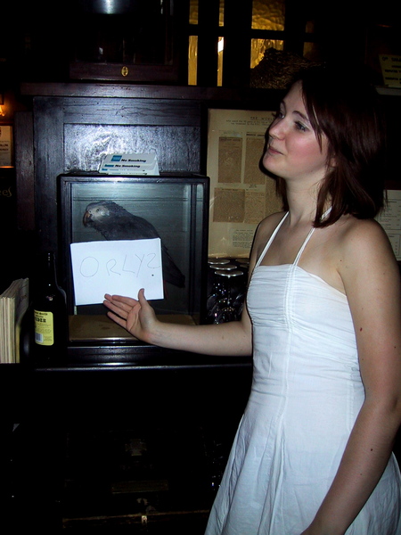 a woman in a white dress is holding a piece of paper