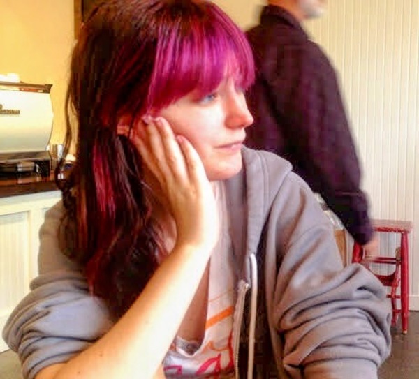 a woman sitting at a table with a laptop