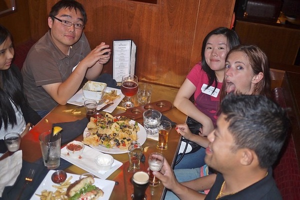 a group of people sitting around a table eating