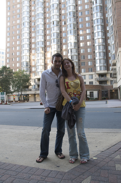 a man and woman standing on a sidewalk