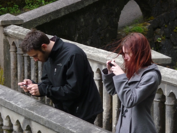 a man and woman standing on a bridge