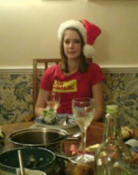 a woman sitting at a table with a plate of food