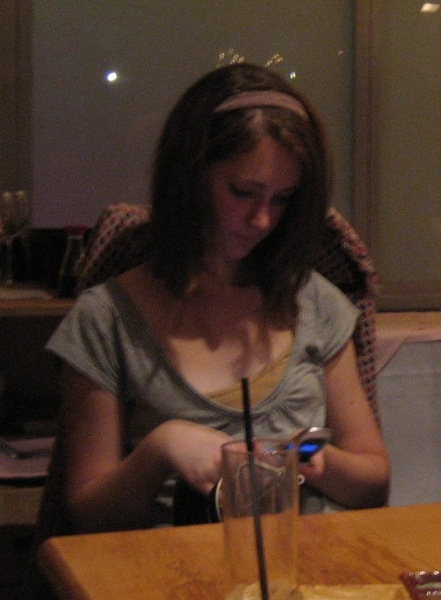 a woman sitting at a table with a glass of water