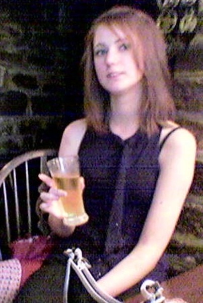 a woman sitting on a chair holding a drink