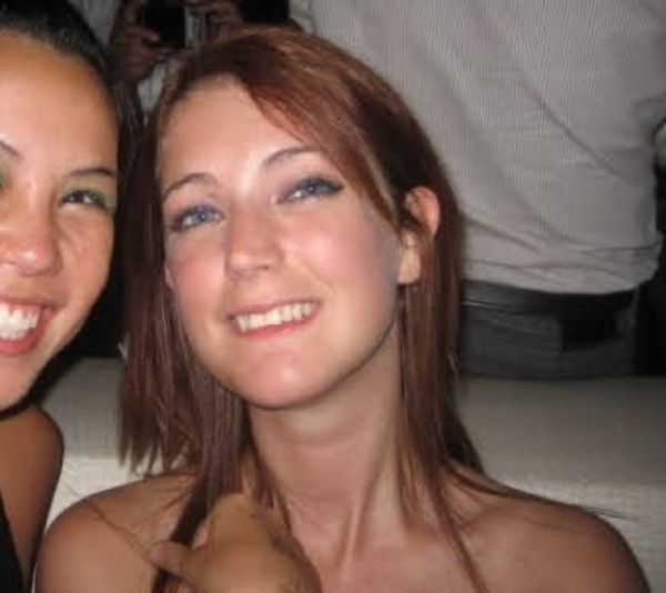 two women are smiling and posing for the camera