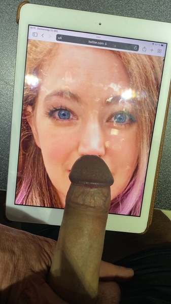 a person with a fake penis and a tablet