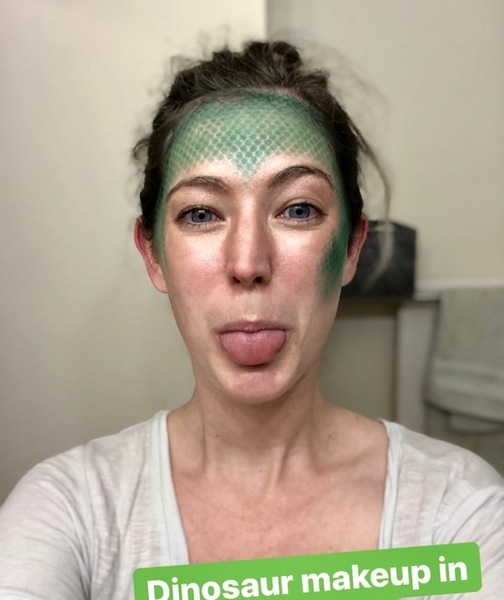 a woman with green makeup and a green face mask