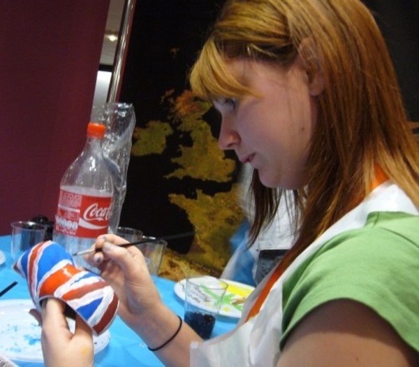 a woman is painting a picture on a table