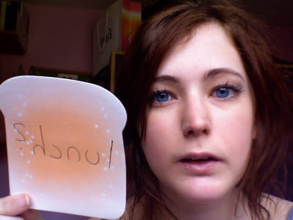 a woman holding a piece of paper with writing on it