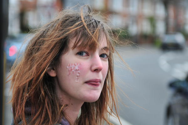 a woman with a piece of food on her face