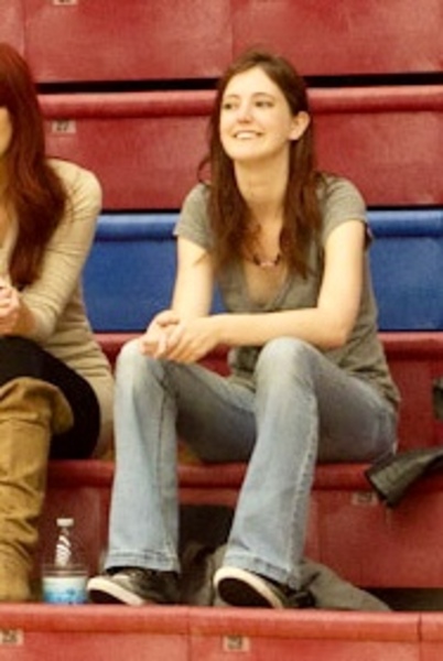 two girls sitting on the bleachers