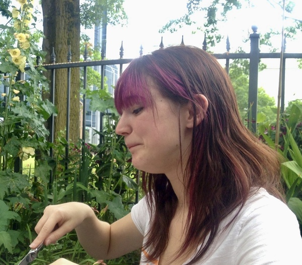 a woman is cutting a piece of food