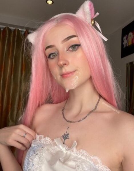 a woman in a white dress and pink hair