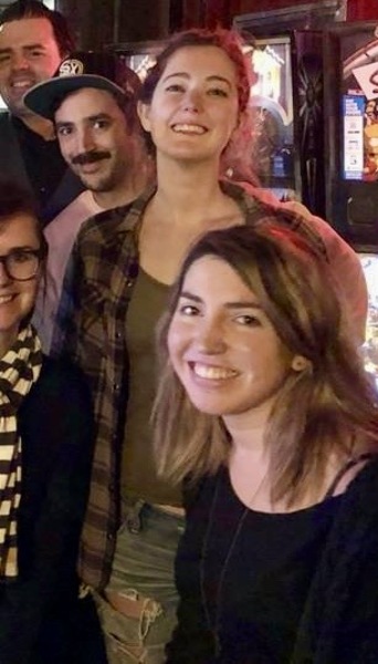 a group of people standing in front of a bar