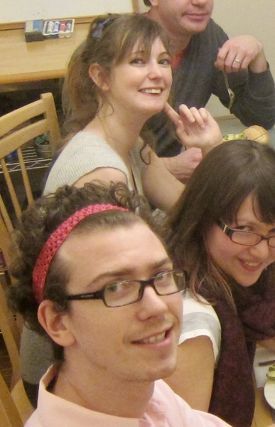 a group of people sitting at a table eating