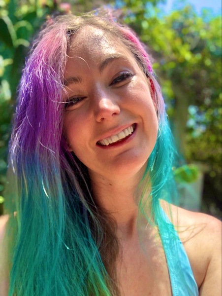 a woman with long hair and a blue tank top