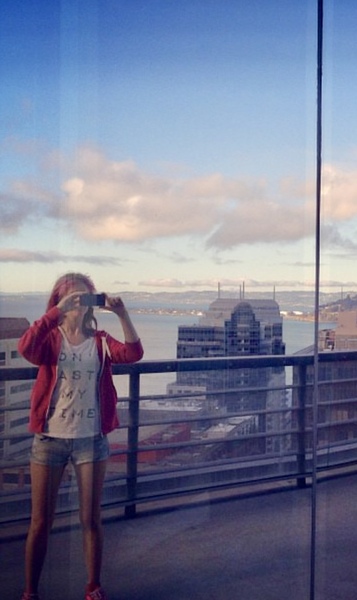 a woman taking a picture of a city