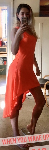 a woman in a red dress taking a selfie