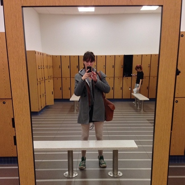 a man taking a picture of himself in a locker room