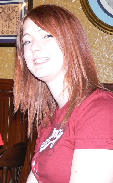 a woman sitting at a table with a plate of food