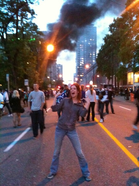 a woman is standing in the middle of a street