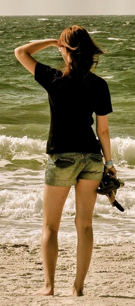 a woman standing on the beach