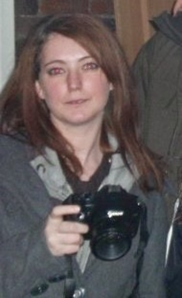 a man and woman are holding cameras