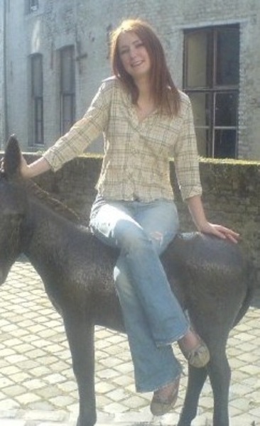 a woman sitting on top of a horse