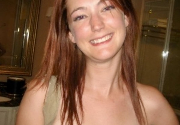 a woman with long red hair and a green shirt