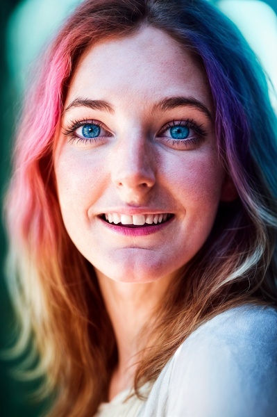 a woman with pink hair and blue eyes